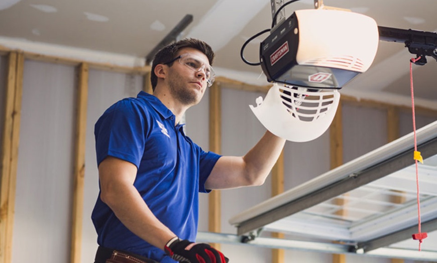 Garage door motor being serviced during a routine tune-up