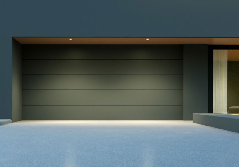Flush dark sectional garage door on a contemporary house